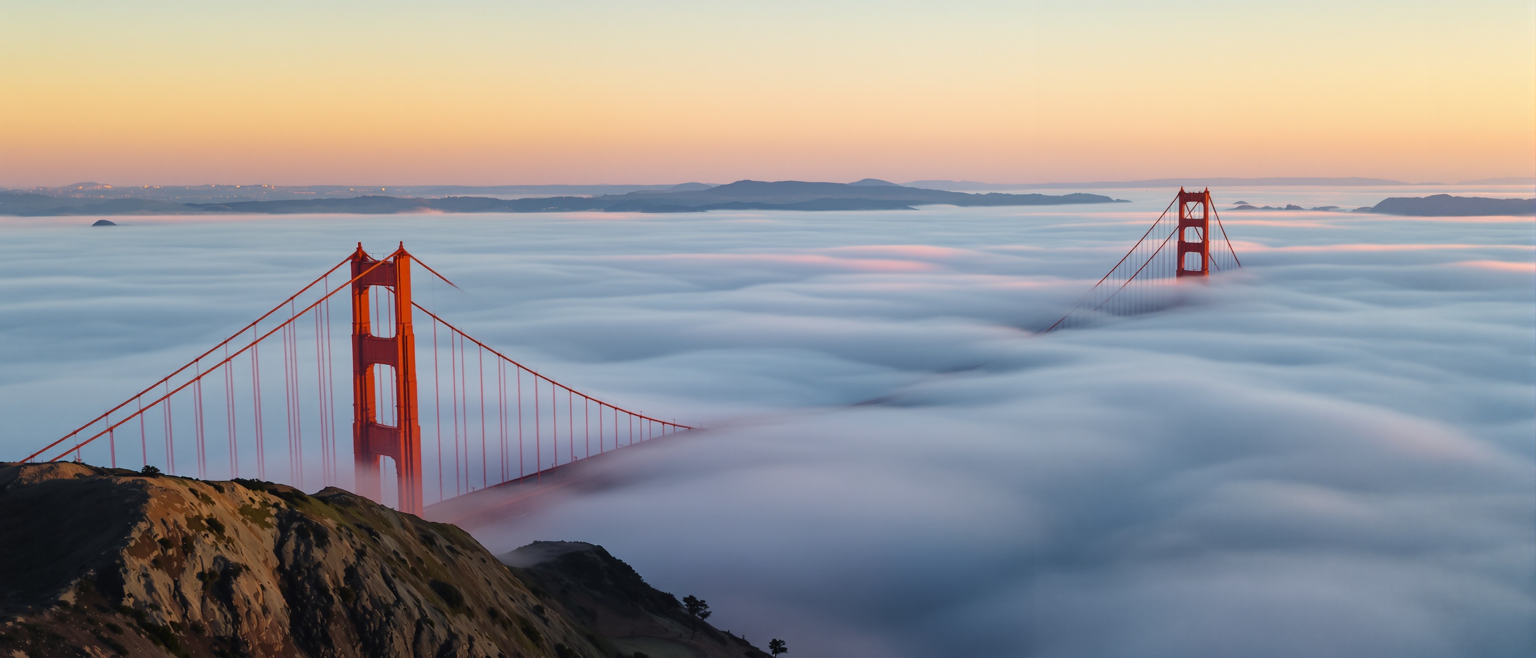A gate of towers in the clear air at dawn.